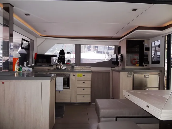Meow Or Never Yacht Photos Pics Modern interior of 2020 Leopard 45 catamaran with sleek kitchen and seating area.