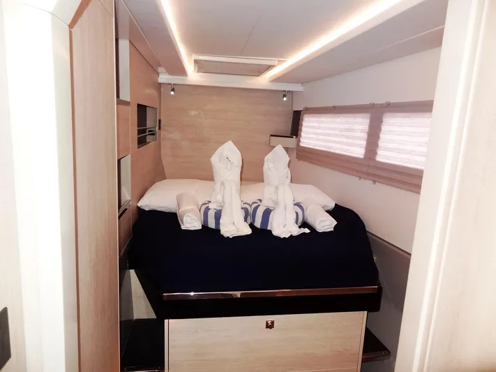 Meow Or Never Yacht Photos Pics Luxurious cabin interior of 2020 Leopard 45 yacht with elegant bedding and towel art.