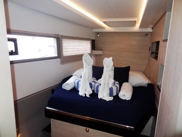 Meow Or Never Yacht Photos Pics Luxurious cabin interior of 2020 Leopard 45 yacht with elegant towel art on bed.