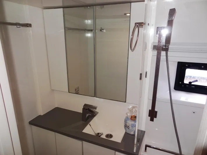 Meow Or Never Yacht Photos Pics Modern bathroom in 2020 Leopard 45 yacht with sleek fixtures and mirrored cabinets.