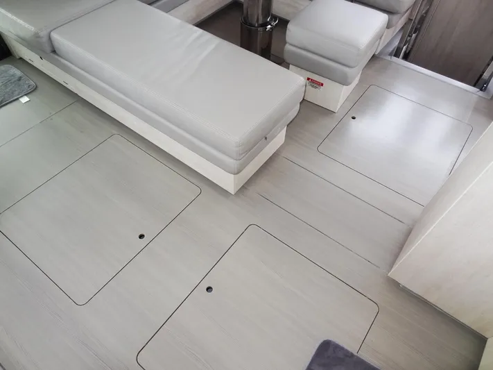 Meow Or Never Yacht Photos Pics Modern interior of 2020 Leopard 45 yacht with sleek seating and storage compartments.