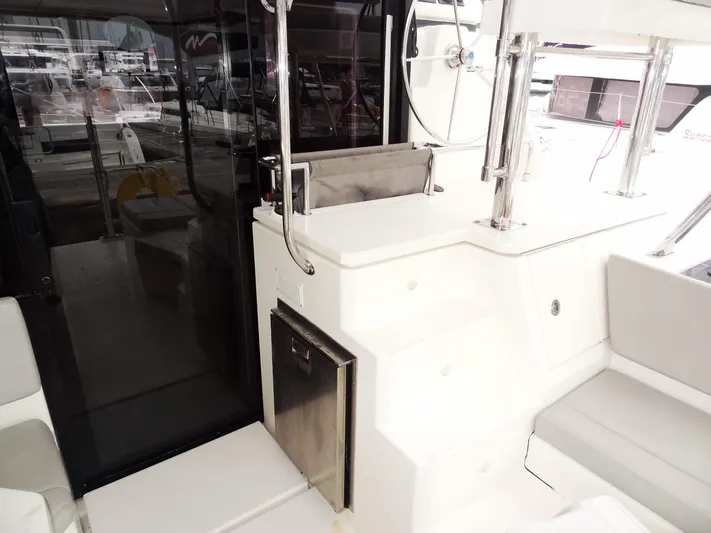 Meow Or Never Yacht Photos Pics 2020 Leopard 45 yacht interior with sleek white seating and stainless steel accents.