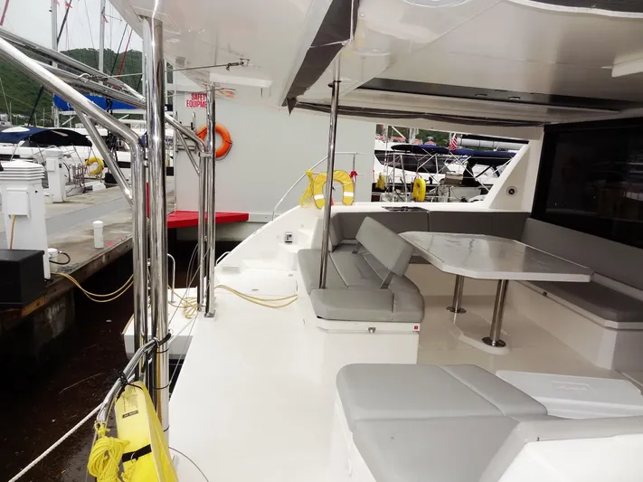 Meow Or Never Yacht Photos Pics Leopard 45 catamaran, 2020 model, featuring spacious outdoor seating and dining area at the dock.