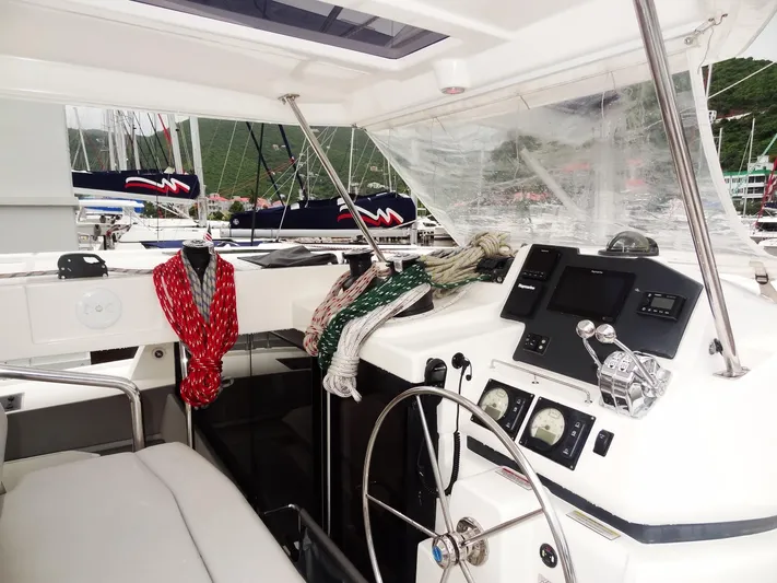 Meow Or Never Yacht Photos Pics Interior of 2020 Leopard 45 yacht cockpit with steering wheel and navigation controls.