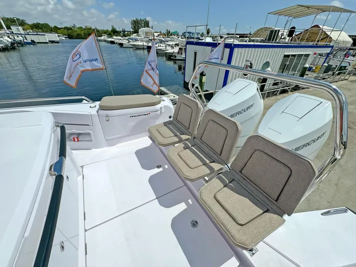  Yacht Photos Pics 2025 Axopar 37 Sun Top boat with seating and twin engines at a marina.