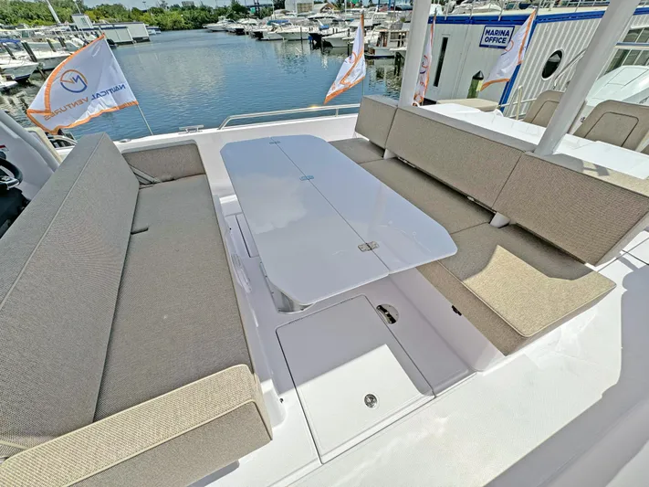  Yacht Photos Pics 2025 Axopar 37 Sun Top boat with spacious seating and table, docked at marina.
