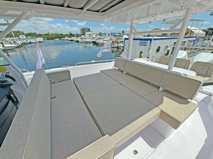  Yacht Photos Pics 2025 Axopar 37 Sun Top boat with spacious seating, docked at a marina.