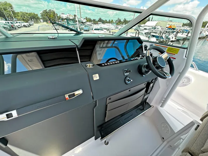  Yacht Photos Pics 2025 Axopar 37 Sun Top helm with modern controls and sleek design.