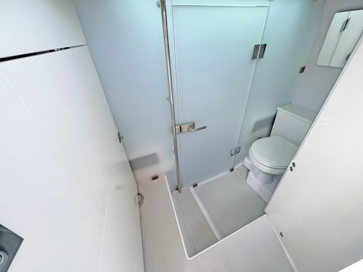  Yacht Photos Pics 2025 Axopar 37 Sun Top bathroom with modern shower and toilet.