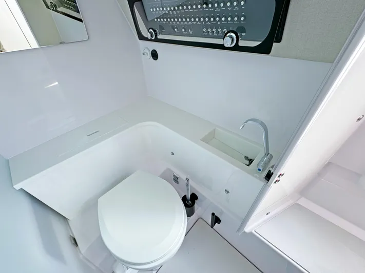 Yacht Photos Pics 2025 Axopar 37 Sun Top bathroom with modern fixtures and sleek design.
