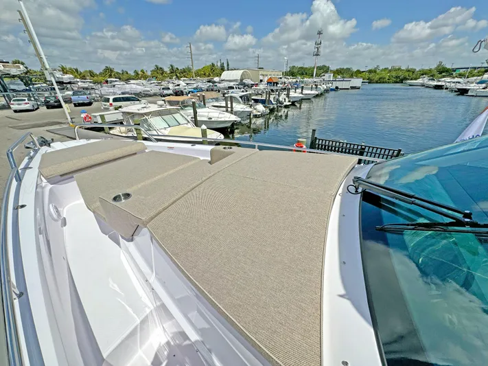  Yacht Photos Pics 2025 Axopar 37 Sun Top boat docked at a marina under a clear blue sky.