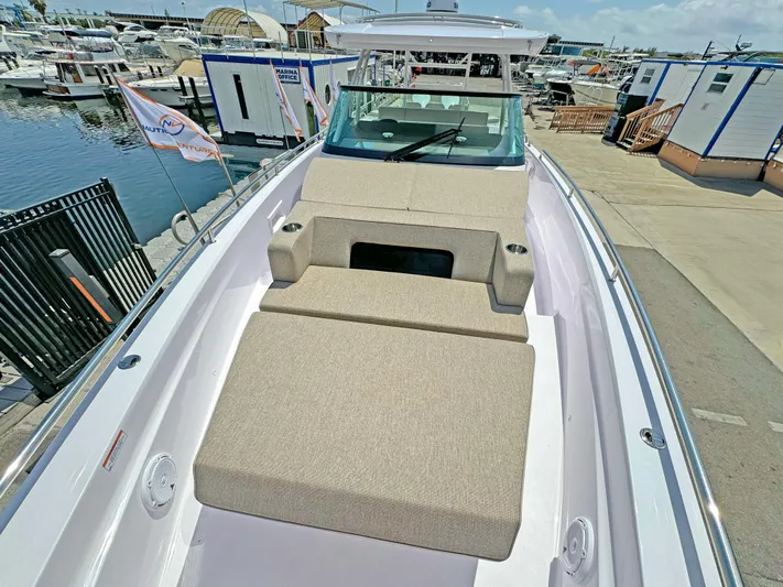  Yacht Photos Pics 2025 Axopar 37 Sun Top boat with spacious sunbathing area at marina.