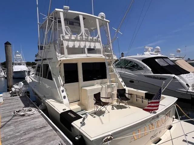  Yacht Photos Pics 1993 Viking 45 Convertible yacht docked, featuring a spacious deck and American flag.