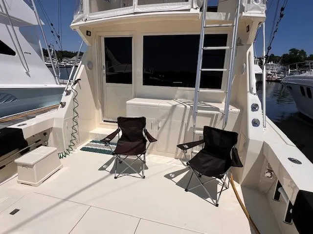  Yacht Photos Pics 1993 Viking 45 Convertible yacht deck with chairs and ladder in marina.