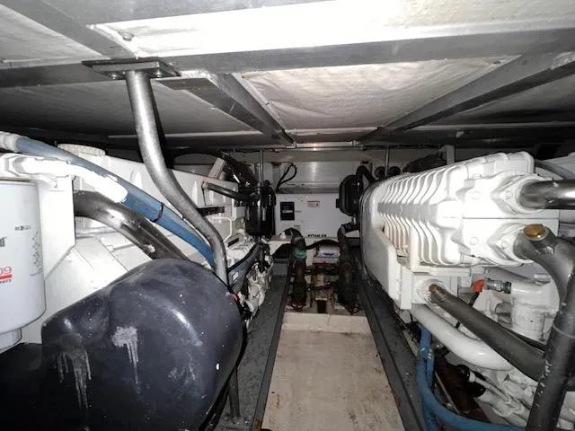  Yacht Photos Pics Engine room of 1993 Viking 45 Convertible yacht, showcasing dual engines and mechanical components.