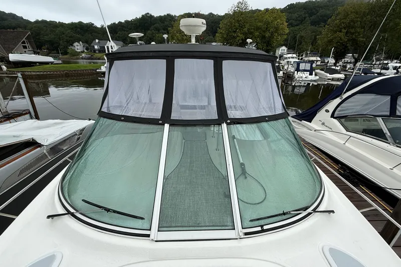 Houligan's Haven Yacht Photos Pics 2004 Cruisers 370 Express yacht docked at marina, featuring sleek windshield and canopy.