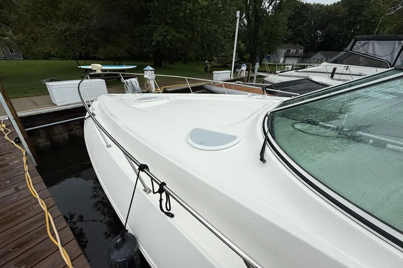 Houligan's Haven Yacht Photos Pics 2004 Cruisers 370 Express yacht docked, featuring sleek white design and spacious deck.