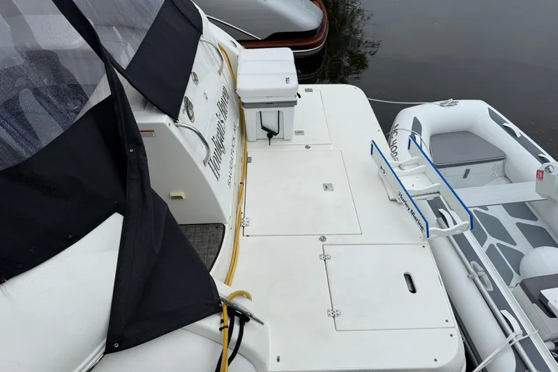 Houligan's Haven Yacht Photos Pics 2004 Cruisers 370 Express yacht with attached inflatable boat at dockside.