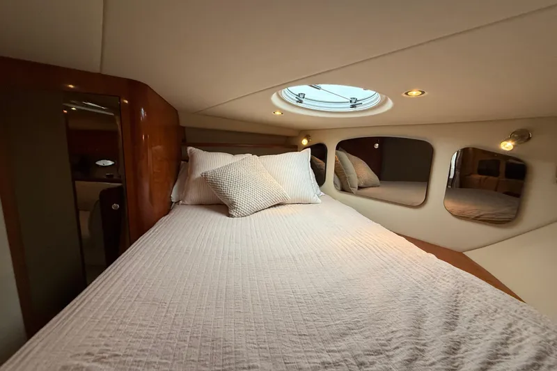 Houligan's Haven Yacht Photos Pics Luxurious cabin interior of 2004 Cruisers 370 Express yacht with cozy bedding.