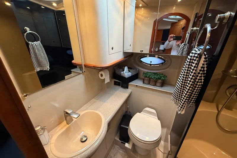 Houligan's Haven Yacht Photos Pics Luxurious 2004 Cruisers 370 Express yacht bathroom with modern fixtures and elegant decor.
