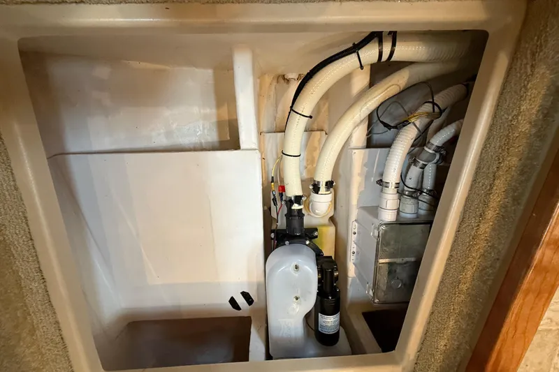 Houligan's Haven Yacht Photos Pics 2004 Cruisers 370 Express engine compartment with hoses and mechanical components.