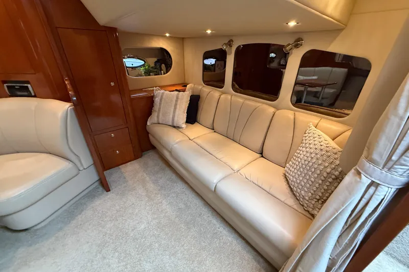 Houligan's Haven Yacht Photos Pics Luxurious interior of 2004 Cruisers 370 Express yacht with beige leather seating.