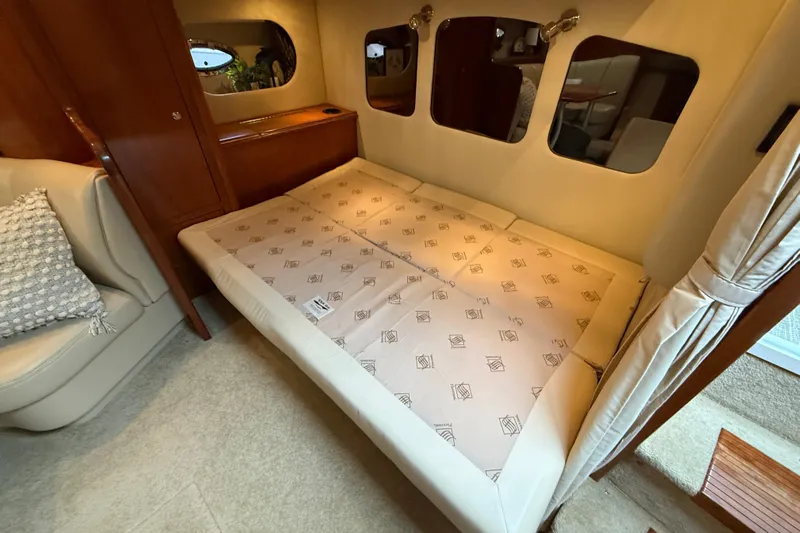 Houligan's Haven Yacht Photos Pics Interior of 2004 Cruisers 370 Express yacht with cozy bed and elegant wood finish.