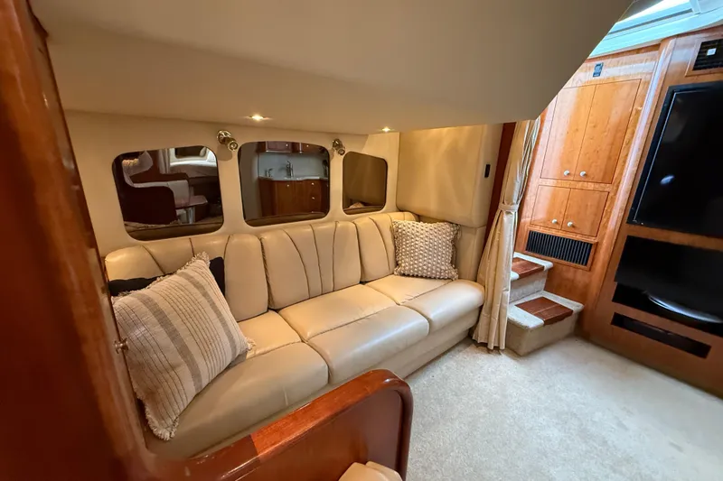 Houligan's Haven Yacht Photos Pics Luxurious interior of 2004 Cruisers 370 Express yacht with beige leather seating.