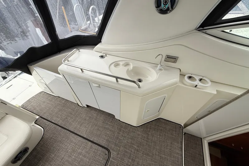 Houligan's Haven Yacht Photos Pics 2004 Cruisers 370 Express yacht interior with sink and storage cabinets.