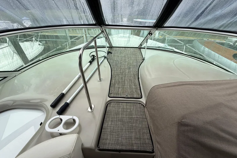 Houligan's Haven Yacht Photos Pics 2004 Cruisers 370 Express boat deck with railing and covered seating area.