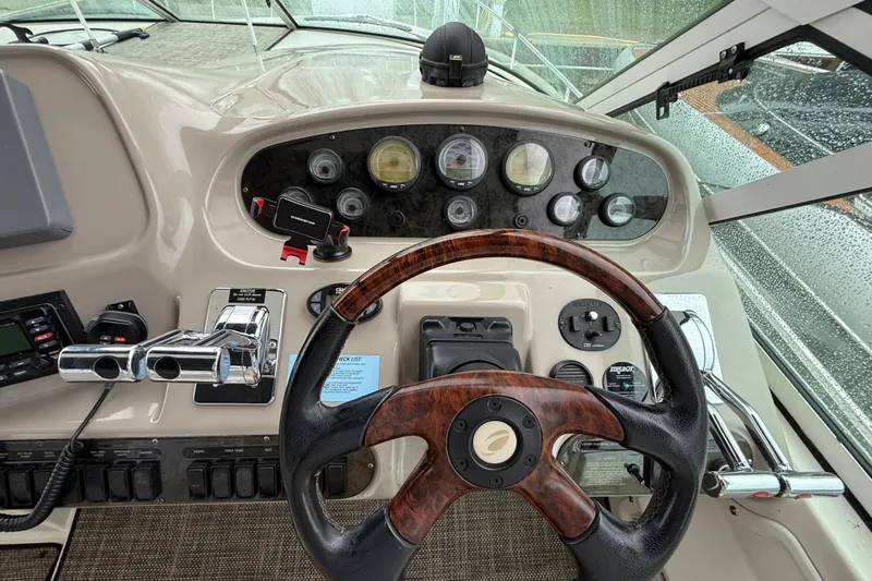 Houligan's Haven Yacht Photos Pics Dashboard of a 2004 Cruisers 370 Express boat with steering wheel and controls.