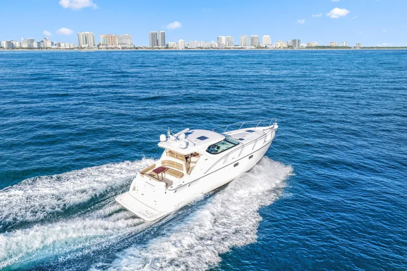  Yacht Photos Pics 2008 Tiara Yachts 4300 Sovran cruising on open water with city skyline backdrop.