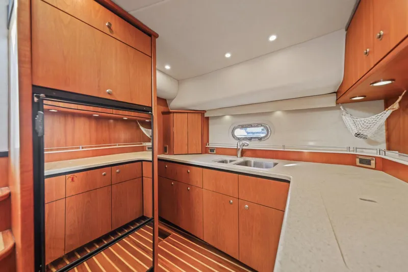  Yacht Photos Pics 2008 Tiara Yachts 4300 Sovran kitchen with wood cabinetry and modern appliances.