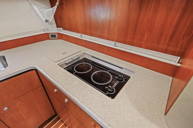  Yacht Photos Pics 2008 Tiara Yachts 4300 Sovran kitchen with electric stove and wooden cabinetry.
