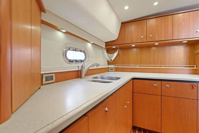  Yacht Photos Pics Luxurious 2008 Tiara Yachts 4300 Sovran kitchen with wood cabinetry and modern fixtures.