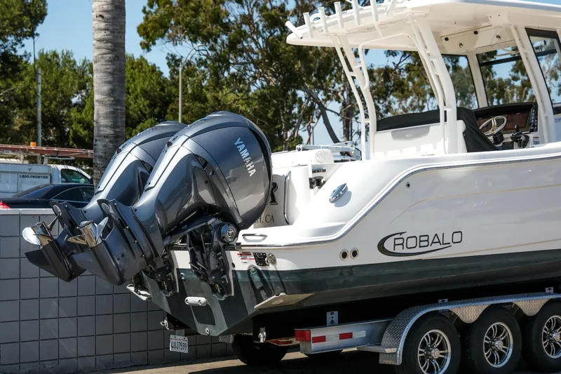 Elixir Yacht Photos Pics 2023 Robalo R302 Center Console boat with dual Yamaha engines on a trailer.