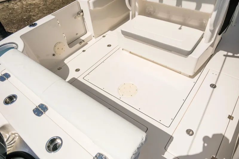 Elixir Yacht Photos Pics 2023 Robalo R302 Center Console boat interior with seating and storage compartments.
