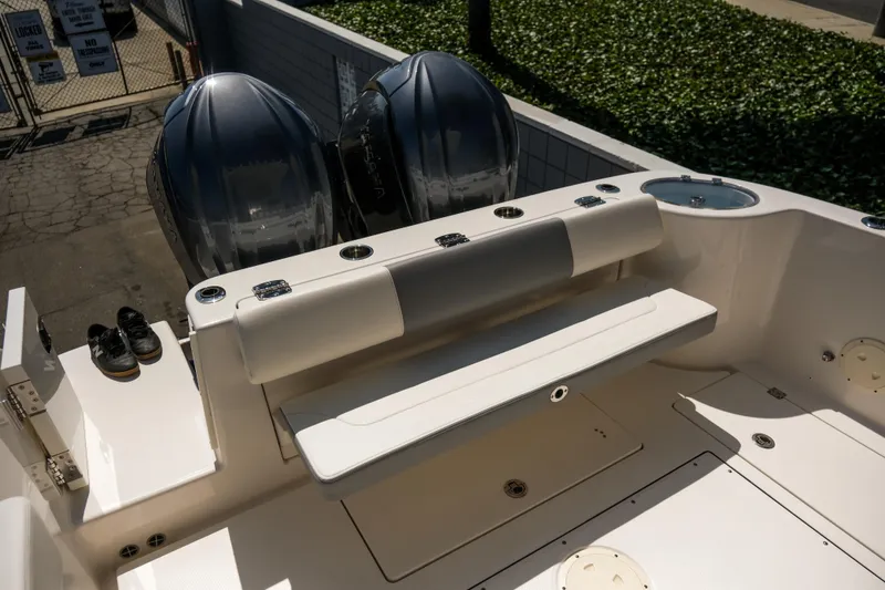 Elixir Yacht Photos Pics 2023 Robalo R302 Center Console boat with dual engines and seating area.
