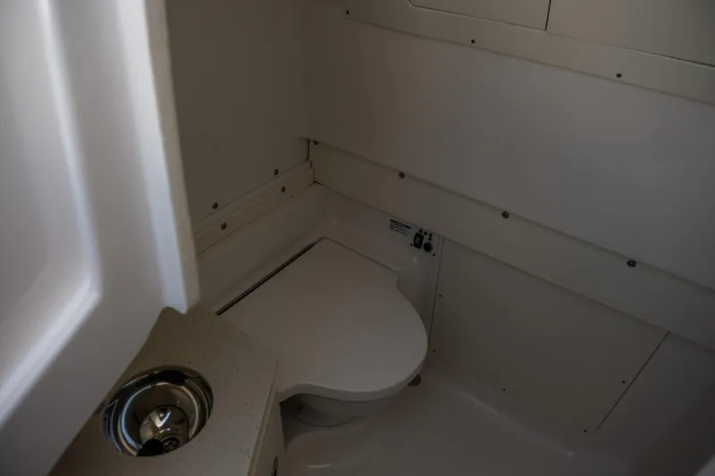Elixir Yacht Photos Pics 2023 Robalo R302 Center Console boat interior bathroom with toilet and sink.