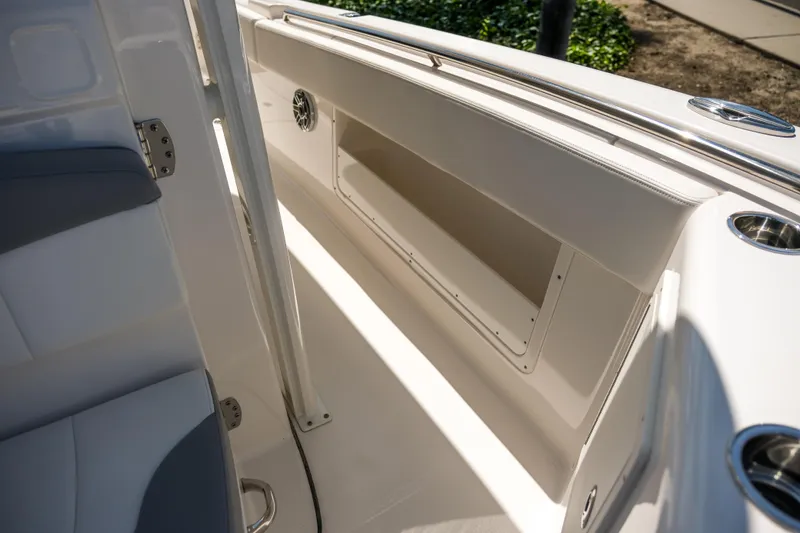 Elixir Yacht Photos Pics 2023 Robalo R302 Center Console interior with storage compartment and seating.
