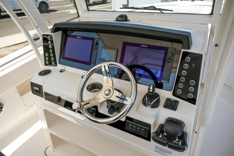 Elixir Yacht Photos Pics 2023 Robalo R302 Center Console boat dashboard with dual navigation screens and steering wheel.