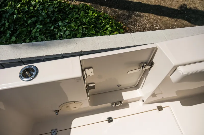 Elixir Yacht Photos Pics 2023 Robalo R302 Center Console boat interior detail with storage compartment.