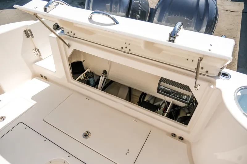 Elixir Yacht Photos Pics 2023 Robalo R302 Center Console boat storage compartment with open hatch.