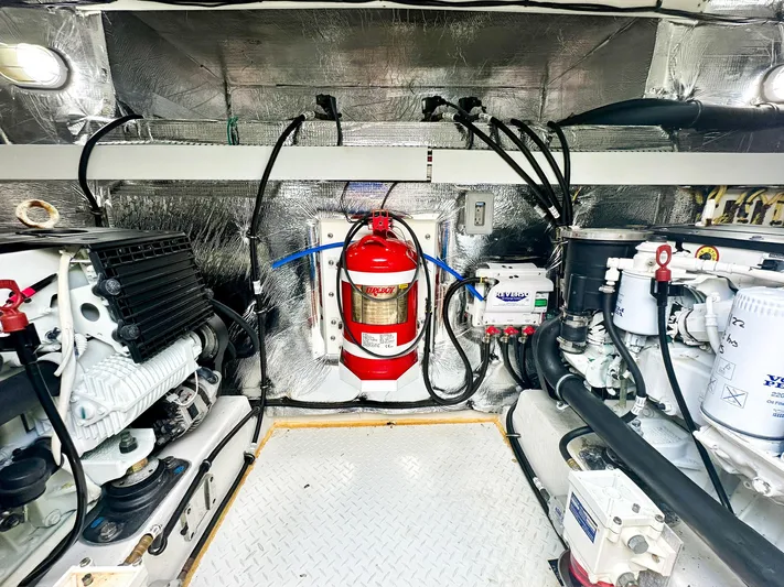  Yacht Photos Pics Engine room of 2016 Cruisers Yachts Cantius 45 with fire extinguisher and equipment.