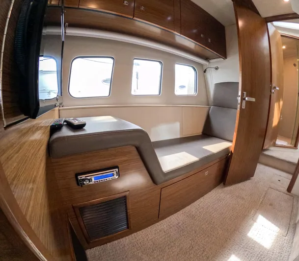  Yacht Photos Pics Interior of 2016 Cruisers Yachts Cantius 45, featuring wood cabinetry and seating area.