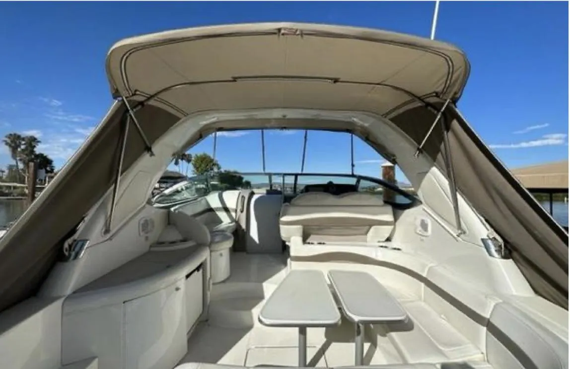 2003 Formula 37 PC yacht interior with seating and table under canopy.