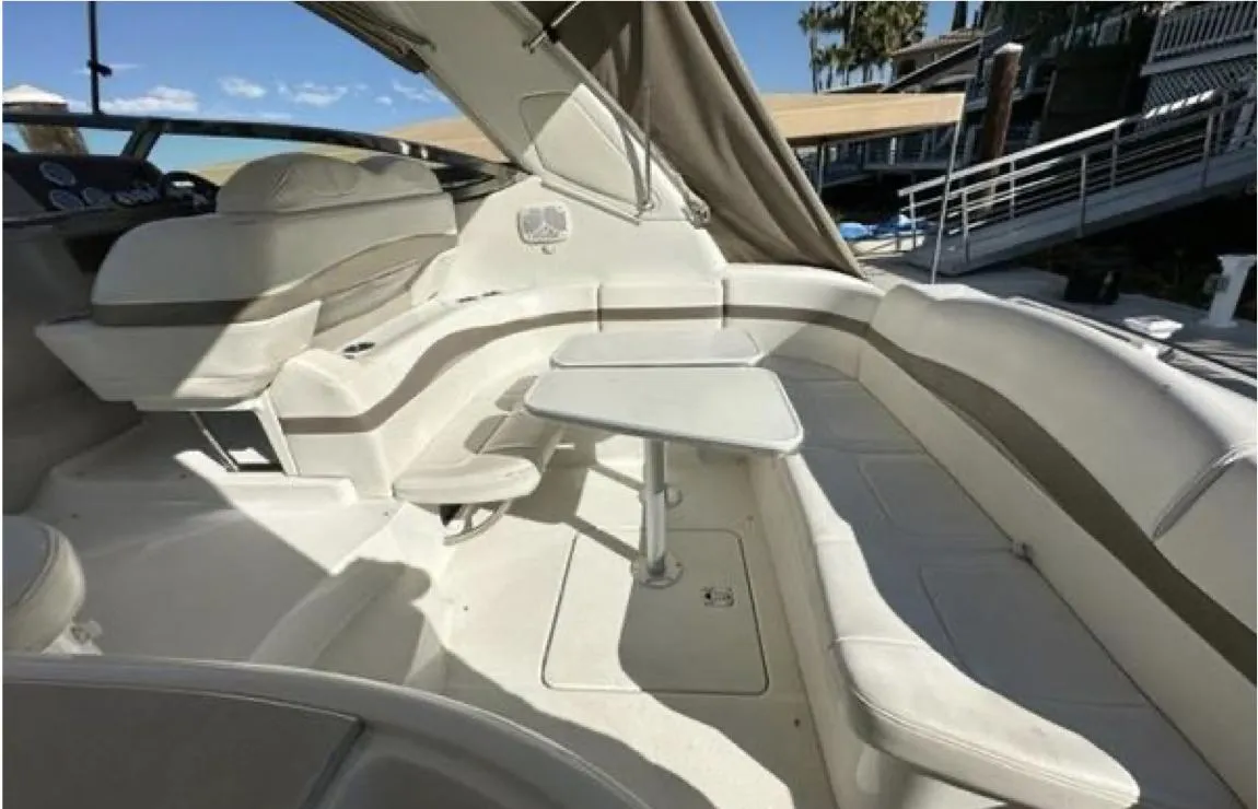 2003 Formula 37 PC yacht interior with seating and table, docked under clear skies.
