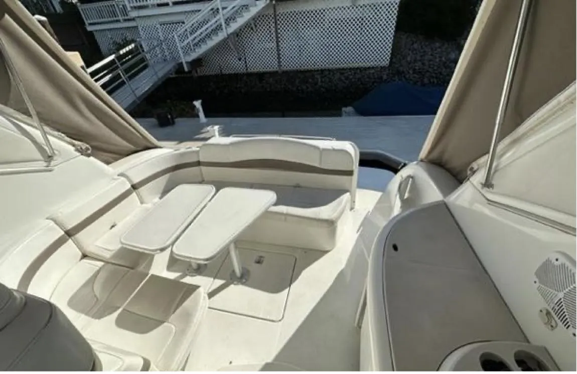 2003 Formula 37 PC yacht interior with seating and table, featuring elegant white upholstery.