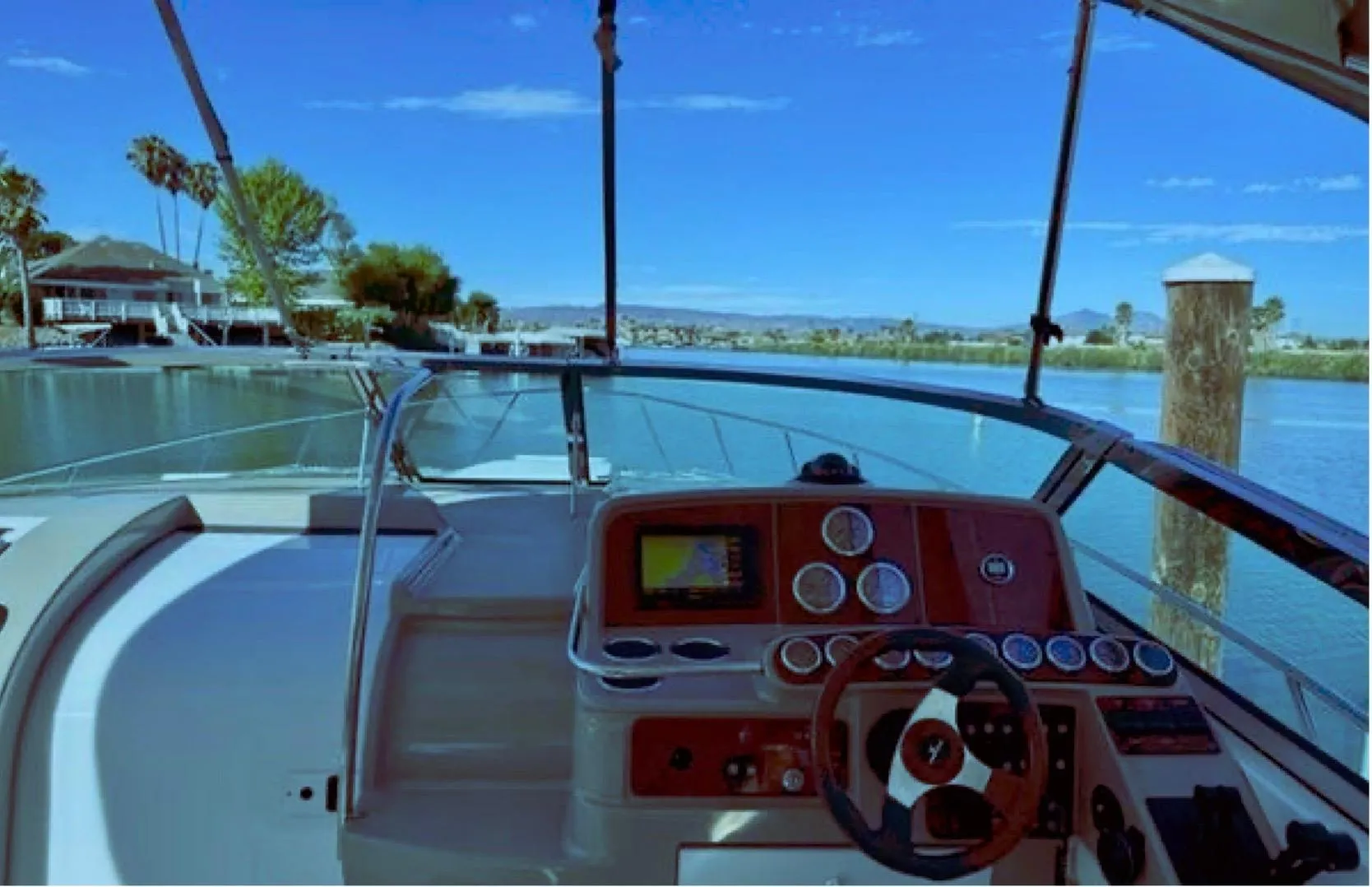 2003 Formula 37 PC boat cockpit with scenic waterfront view.