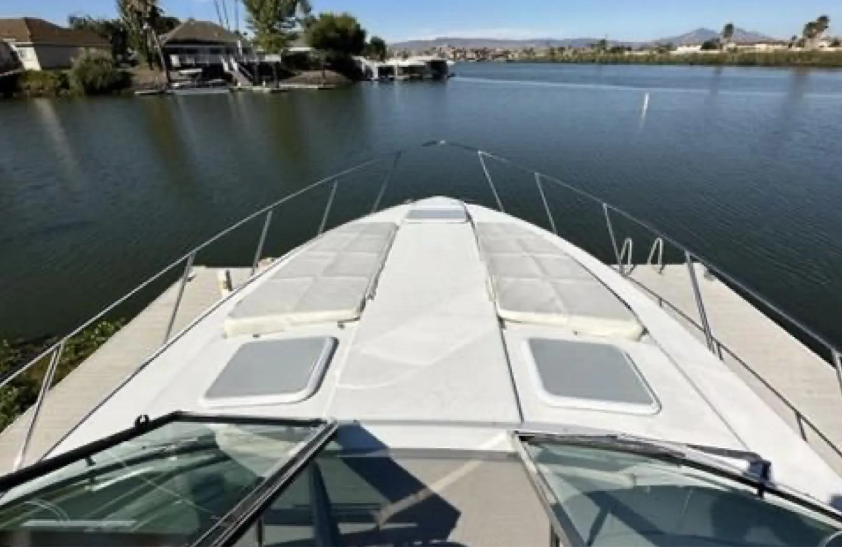 2003 Formula 37 PC yacht on calm water, featuring spacious deck and scenic surroundings.